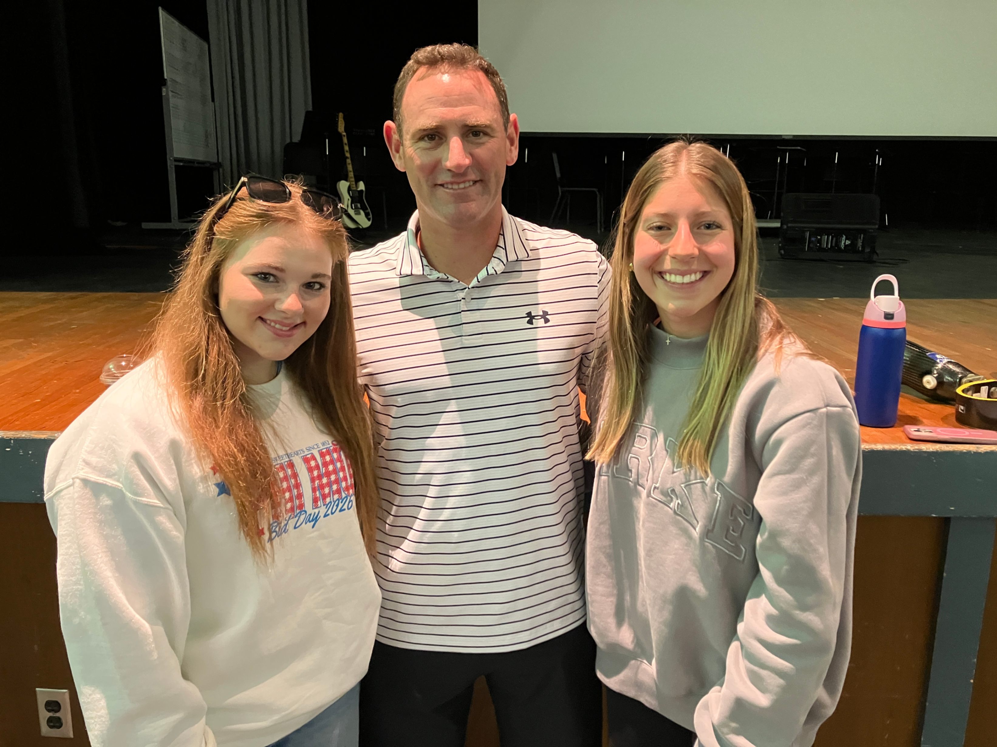 Megan McKinney, Eric McElvenny, and Claira Downs pose for a photo together after Eric's presentation to the high school students.